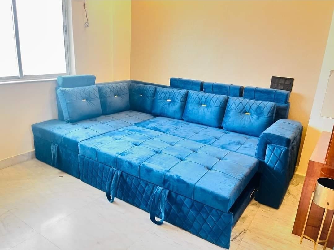 The peacock blue custom L-shape sofa bed opened into an expansive queen sleeping bed