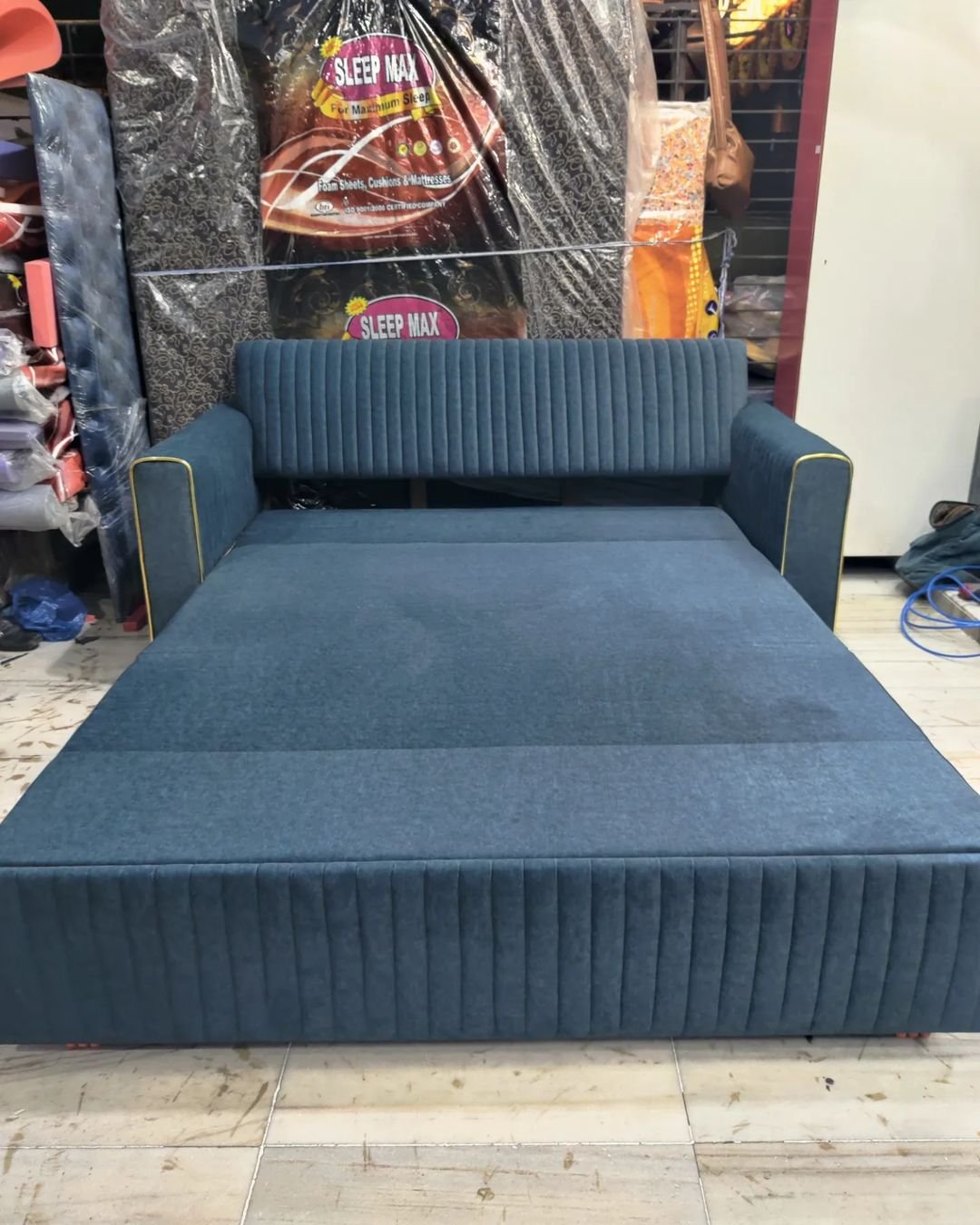 Handcrafted custom sofa cum bed converted into comfortable sleeping bed mode by Refurnix