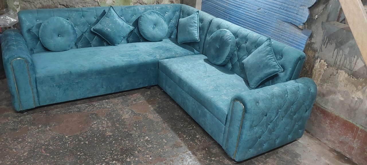 Bespoke teal blue suede sectional sofa with Chesterfield diamond button tufting and round bolsters