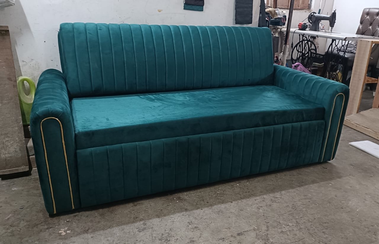 Custom emerald green velvet straight sofa with vertical flute channeling and gold piping