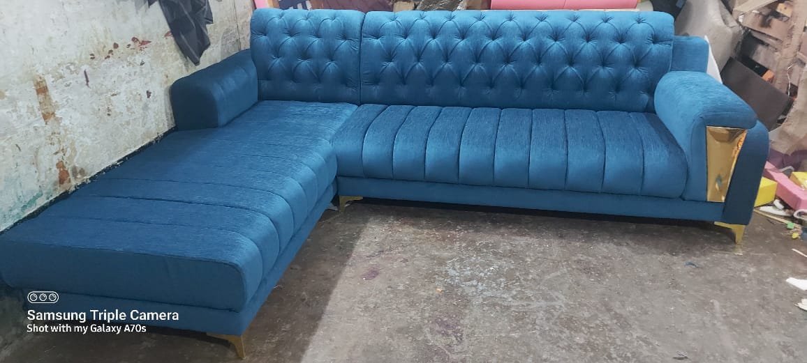 Statement peacock teal blue L-shaped custom sofa with gold metallic accents and legs