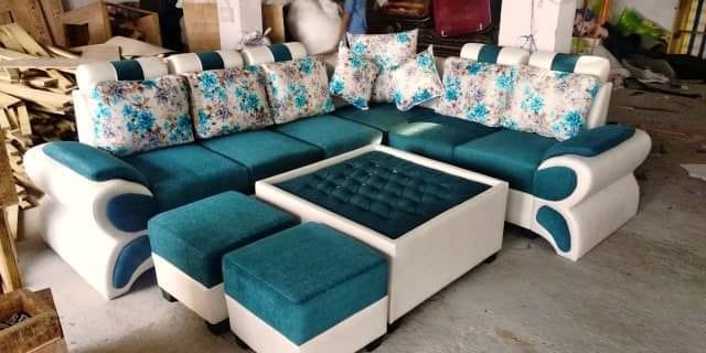 Custom upholstered dining stools and pouf seating with center table in workshop